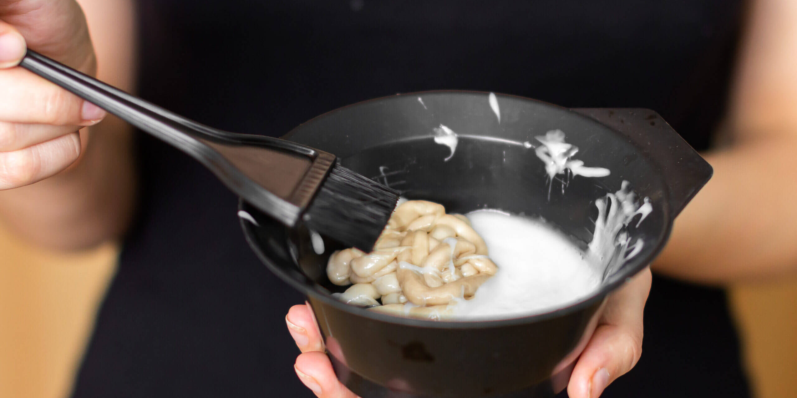 Tools for hair dyeing in woman hands. Colouring of hair at home