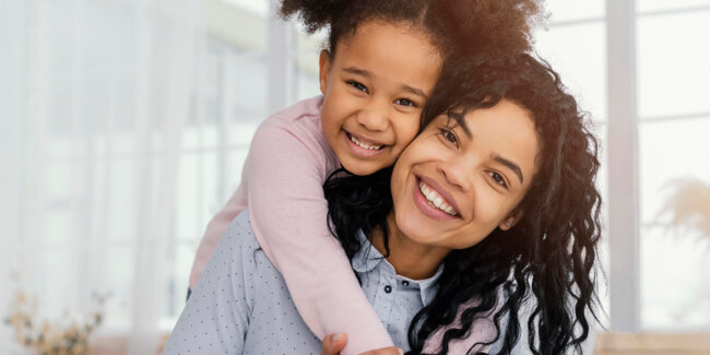 front-view-mother-playing-home-with-her-daughter